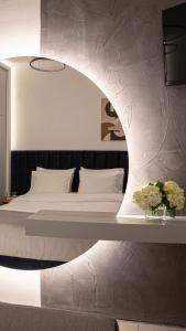 a bedroom with a large bed with a large mirror at Veria Suite in Veria