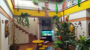 a room with a table and stools and a fish tank at Hotel Manoa in Cúcuta