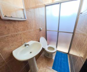 a bathroom with a white sink and a toilet at Pousada Estrela Dourada in Guaratuba +54 photos