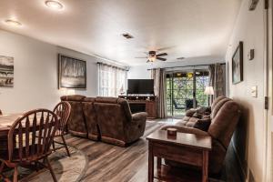 a living room with a couch and a table at Quiet and Serene Condo in Branson in Branson