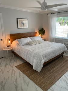 a bedroom with a large bed with a wooden headboard at Villa Venezia in Fort Lauderdale