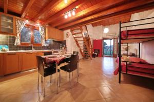 a kitchen and dining room with a table and chairs at Koromilia Villa in Neo Klima