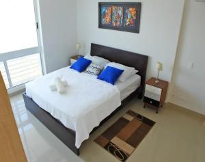 Postel nebo postele na pokoji v ubytování RESERVAS DEL MAR SANTA MARTA Rodadero Sur + 12 fotografií