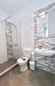 ein Bad mit einem WC, einem Waschbecken und einer Dusche in der Unterkunft Lovely Rooms Finikounda in Finikounda