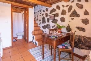 a room with a wooden desk and a toilet at Aldeia da Cuada in Faja Grande