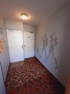 une chambre avec deux portes et un mur orné d'une fresque représentant des joueurs de basket-ball. dans l'établissement Hôtel des Voyageurs, à Ferrières-Saint-Mary