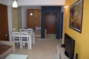 a living room with a television and a table and chairs at Apartment Nika in Ohrid +20 photos