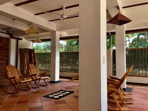 a porch with chairs and a rug on the floor at Donama River in Palomino