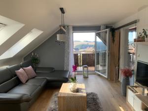 a living room with a couch and a large window at Tolle Ferienwohnung mit Loggia in Schauenstein 100qm bei Hof an der Saale Frankenwald in Schauenstein