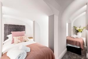 a bedroom with a bed with towels on it at Wine Vaults Apartment in Bath