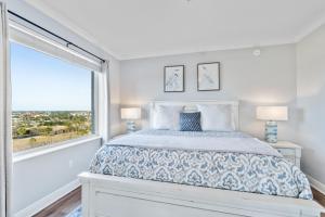 a bedroom with a bed and a large window at Santo Amaro 801B - Lost Key Golf & Beach in Perdido Key +39 photos