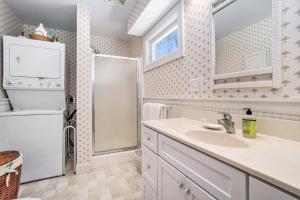 a white bathroom with a sink and a shower at Johnson Cottage in Glenn +18 photos