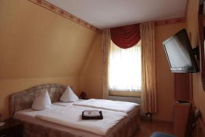 a hotel room with a bed and a television at Hotel Sessellift in Koblenz