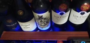 a row of bottles of wine on a shelf at Pousada das Orquídeas in Chapada dos Guimarães