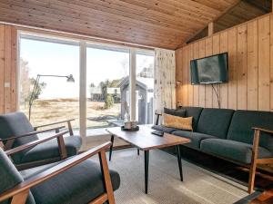 a living room with a couch and a table at 4 person holiday home in L s in Læsø