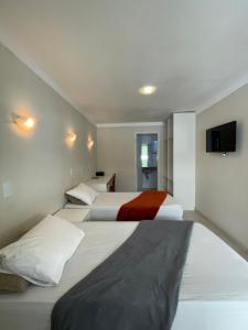 Säng eller sängar i ett rum på Hotel Cantareira