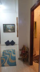 a hallway with a rug and a painting on the wall at Beautiful Apartment Holiday in Casablanca