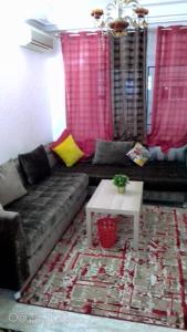 a living room with a couch and a table at Beautiful Apartment Holiday in Casablanca