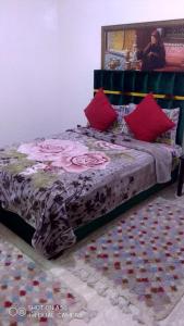 a bedroom with a bed with red pillows on it at Beautiful Apartment Holiday in Casablanca