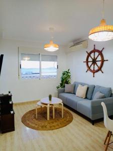 a living room with a blue couch and a table at Mar Menor, La Manga Strip/Best view + Pool in San Blas