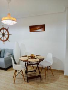 a dining room with a table and white chairs at Mar Menor, La Manga Strip/Best view + Pool in San Blas