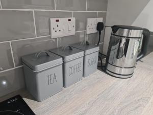 a kitchen with three boxes on the floor next to a blender at 6 Bed sleeps 7, 1 mile from M54 i54 Jaguar Land Rover MOOG in Wolverhampton