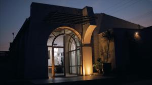 a building with an arch doorway with a palm tree outside at Casa Legado in Aguascalientes