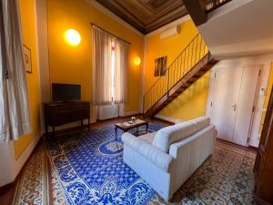 a living room with a couch and a staircase at Al Giglio Bottonato in Florence