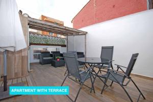 an outdoor patio with a table and chairs at Apartments Valencia, Cabañal in Valencia