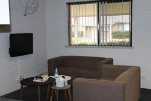 a living room with a couch and a table at Western Sydney University Village - Hawkesbury in Richmond