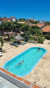 two birds swimming in a swimming pool in a resort at Suites em Canoa Quebrada in Aracati