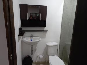 a small bathroom with a toilet and a sink at Apartamento tipo Loft in Medellín