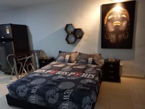 a bedroom with a bed with a picture of a face on the wall at Apartamento tipo Loft in Medellín