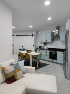 salon z białą kanapą i kuchnią w obiekcie Riviera Beach AL w mieście Praia da Vitória