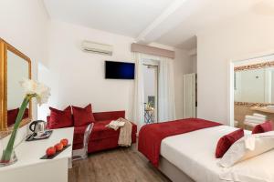 a hotel room with two beds and a tv at Hotel Navona in Rome