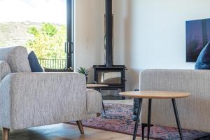 a living room with two chairs and a table at Relax in Style in Clyde