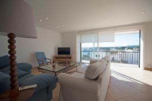 a living room with a couch and a table at Can Alou, Village House With Mediterranean Charme in Felanitx