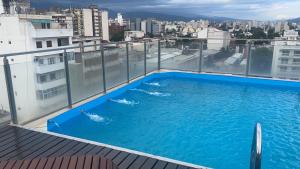 a swimming pool on the roof of a building at Departamento Lindo Colonial Salta in Salta