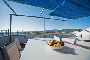 a bowl of fruit on a table on a balcony at Can Alou, Village House With Mediterranean Charme in Felanitx
