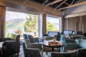 a waiting room with chairs and tables and a large window at The Caledonian Hotel in Fort William