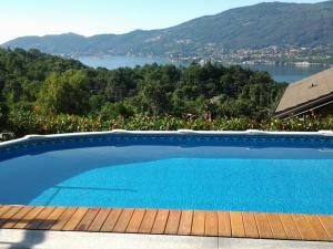 a swimming pool with a view of a lake and mountains at Casa delle Betulle in Verbania