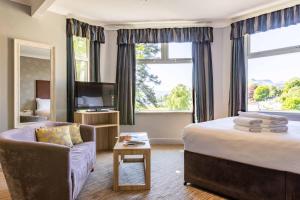 a hotel room with a bed and a couch at The Derwentwater Hotel in Keswick +57 photos