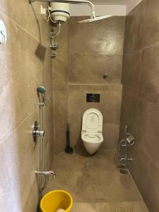 a small bathroom with a toilet in a stall at Corsican Haveli in Jodhpur