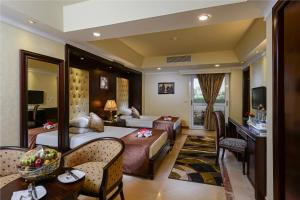 a hotel room with a bed and a living room at Mirita Hotel ,10th Of Ramadan in Madinat Al Ashir min Ramadan