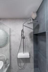 a bathroom with a shower with a toilet and a sink at Apartments Bobo in Dubrovnik