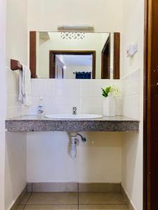 a bathroom with a sink and a mirror at Dala Heights in Mombasa
