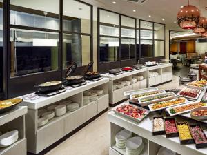 a buffet line with food on display in a restaurant at Hotel Village Izukogen in Ito