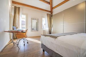 a bedroom with a bed and a desk with a laptop at Colleoni Apartment with 2 Superb Terraces in Venice