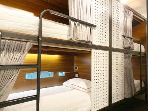 a couple of bunk beds in a room at 台中21旅宿-自助入住 in Taichung