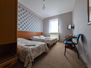 Кровать или кровати в номере Dworek Tucholski